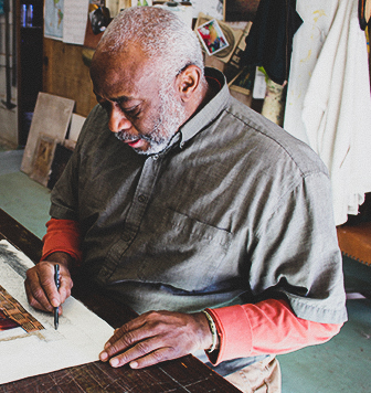 A local artist draws during an art workshop