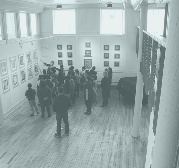 A group tours an art exhibition at the Community Center