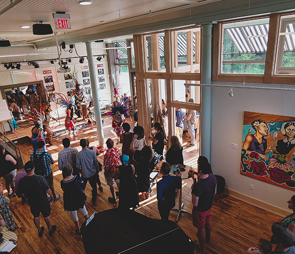 A small crowd watches a performing arts exhibition