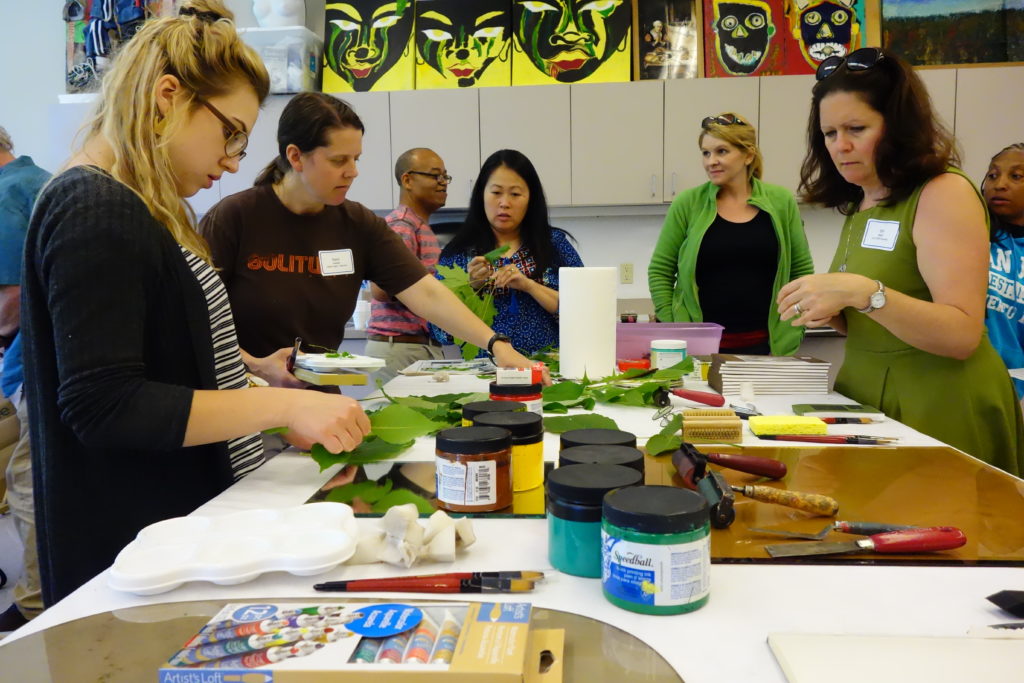 A group of teachers collaborate together while attending a teacher education program